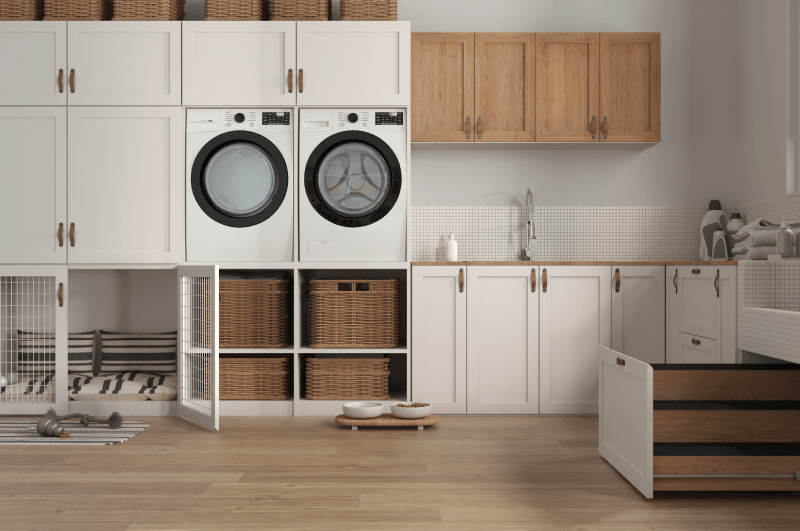 Completed white cabinetry, showcasing a large amount of storage space in a modern-style laundry room.<br />
